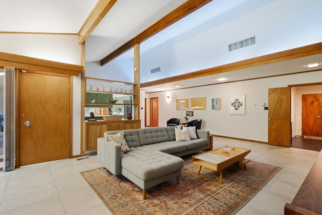 living room with beam ceiling, light tile patterned floors, and high vaulted ceiling