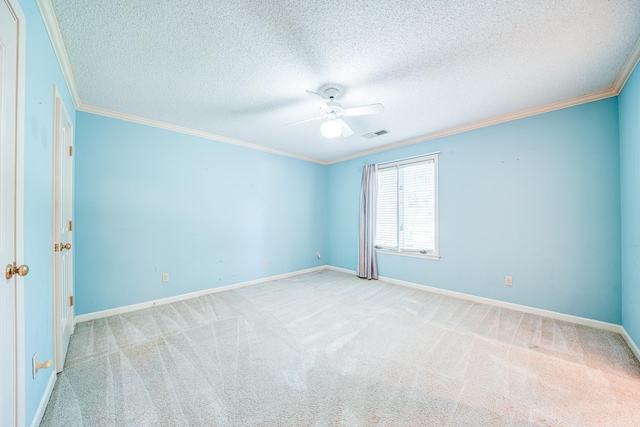 carpeted spare room featuring ornamental molding, a textured ceiling, and ceiling fan