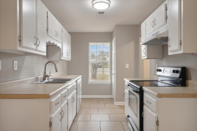 kitchen with sink, a textured ceiling, stainless steel electric stove, white cabinetry, and light tile patterned floors