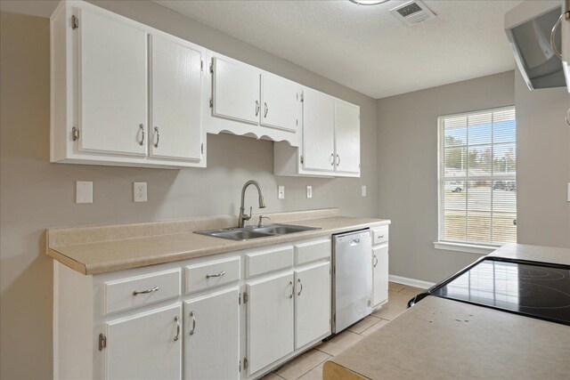 kitchen with white cabinetry, light tile patterned flooring, sink, and dishwasher