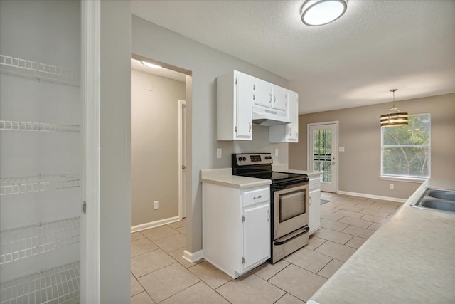 kitchen featuring light tile patterned flooring, pendant lighting, white cabinets, a textured ceiling, and electric stove