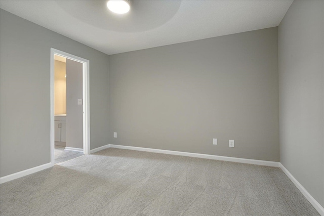 spare room featuring light colored carpet