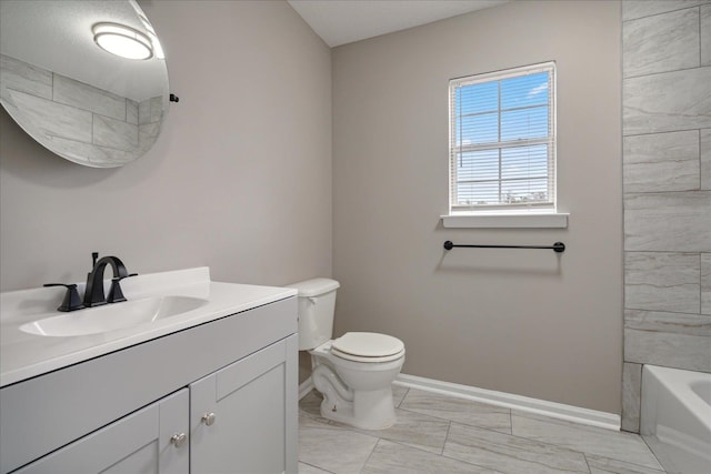 full bathroom with tiled shower / bath, vanity, and toilet