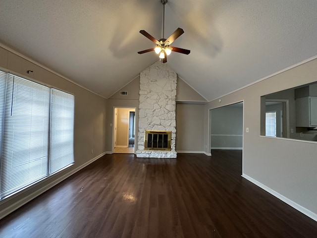 unfurnished living room with dark hardwood / wood-style floors, a healthy amount of sunlight, a fireplace, and ceiling fan