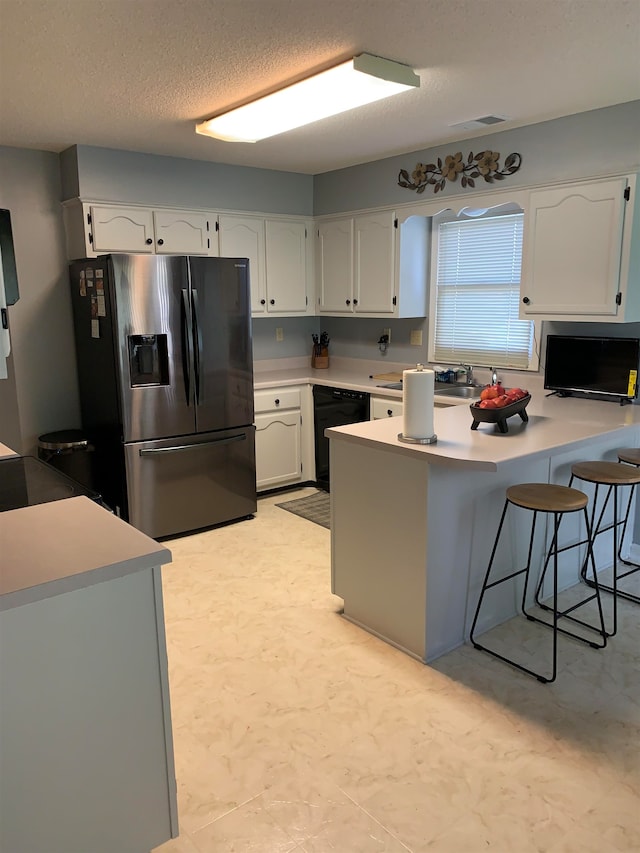 kitchen with black dishwasher, stainless steel refrigerator with ice dispenser, kitchen peninsula, a breakfast bar, and white cabinetry