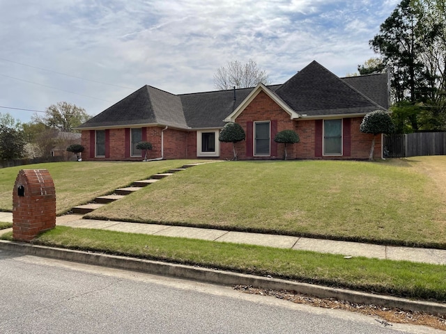 ranch-style home featuring a front yard