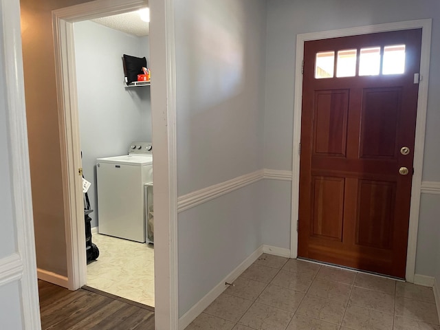 entrance foyer featuring light hardwood / wood-style floors and washer / clothes dryer