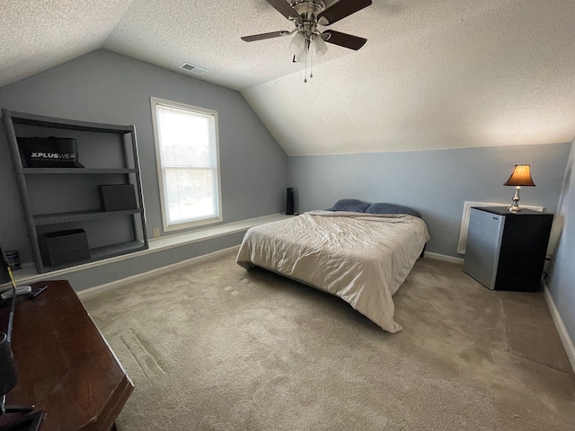 carpeted bedroom featuring a textured ceiling, lofted ceiling, ceiling fan, and stainless steel fridge