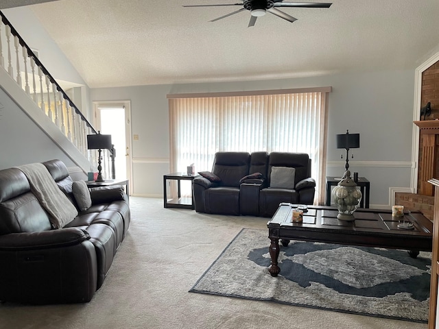 carpeted living room featuring ceiling fan, a textured ceiling, and vaulted ceiling