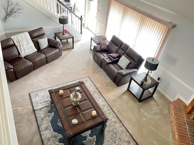 carpeted living room featuring a textured ceiling