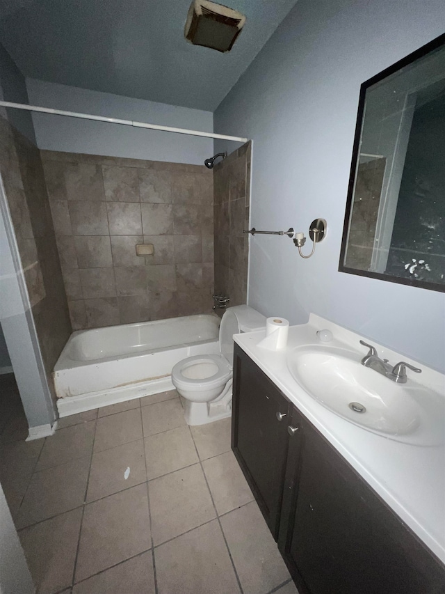 full bathroom with vanity, toilet, tiled shower / bath combo, and tile patterned flooring