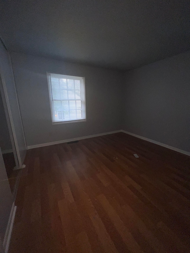 unfurnished room featuring dark hardwood / wood-style floors