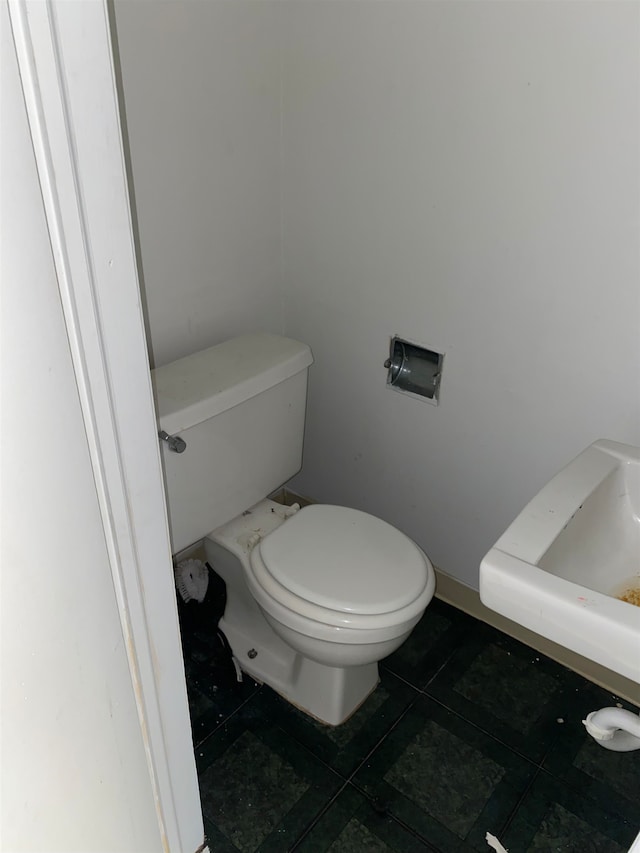 bathroom featuring toilet and tile patterned flooring