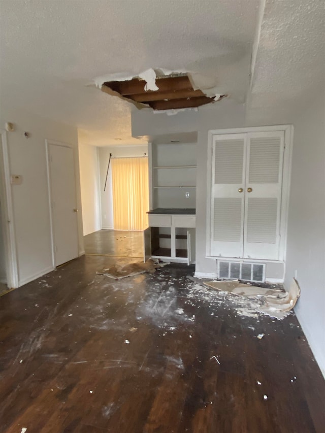 unfurnished living room with a textured ceiling