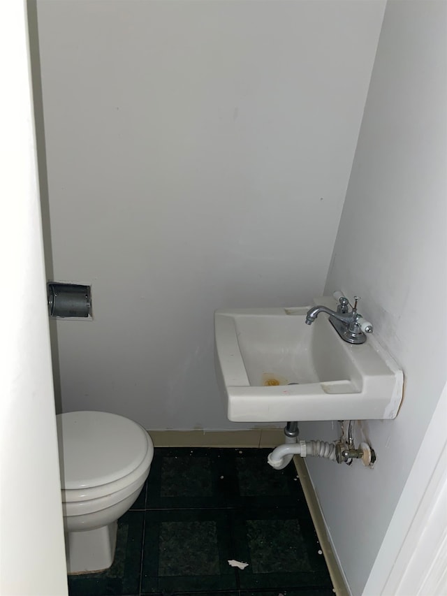 bathroom with tile patterned floors, sink, and toilet