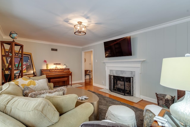 living room with crown molding, hardwood / wood-style floors, and a fireplace