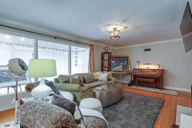 living room featuring crown molding, hardwood / wood-style flooring, and plenty of natural light