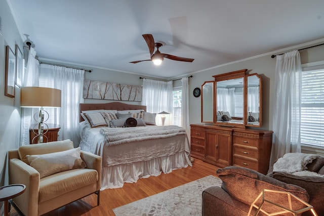 bedroom featuring ornamental molding, light hardwood / wood-style flooring, and ceiling fan