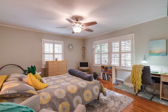 bedroom with ornamental molding, hardwood / wood-style flooring, and ceiling fan