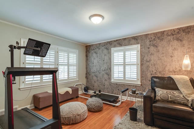 interior space with crown molding, a healthy amount of sunlight, and hardwood / wood-style floors