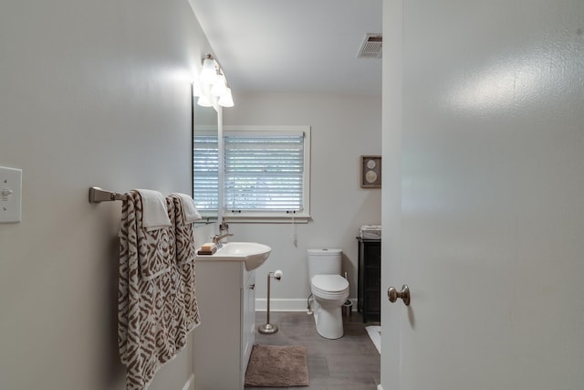 bathroom with toilet and vanity