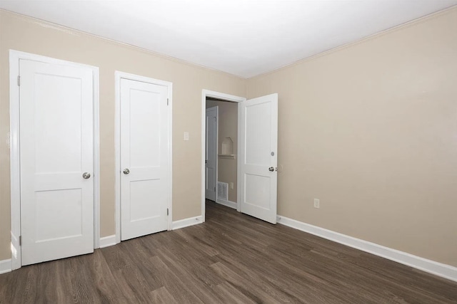 unfurnished bedroom featuring dark hardwood / wood-style floors