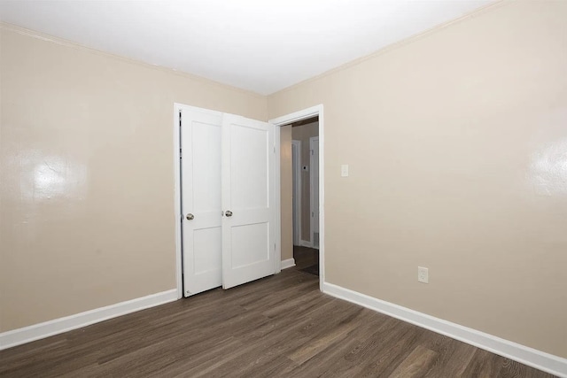 unfurnished bedroom with dark wood-type flooring