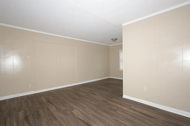 empty room with ornamental molding and dark wood-type flooring