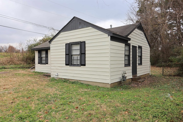 view of home's exterior with a yard