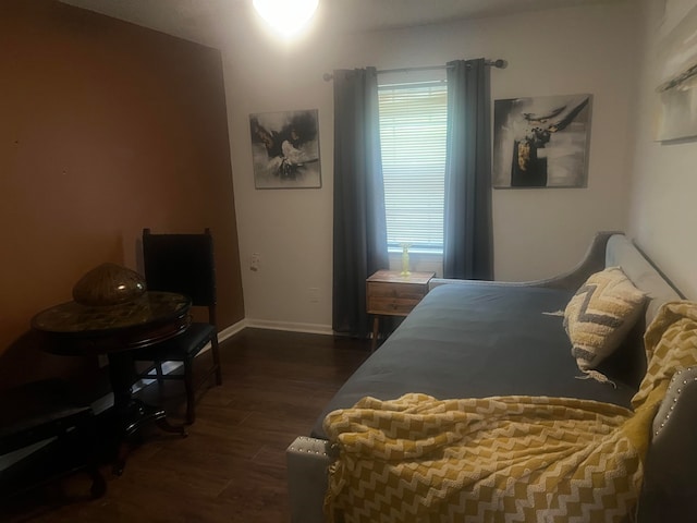 bedroom with dark hardwood / wood-style flooring