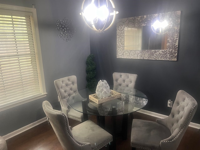 dining room featuring hardwood / wood-style floors and an inviting chandelier