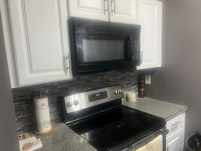 kitchen with decorative backsplash, white cabinets, and stainless steel range with electric cooktop