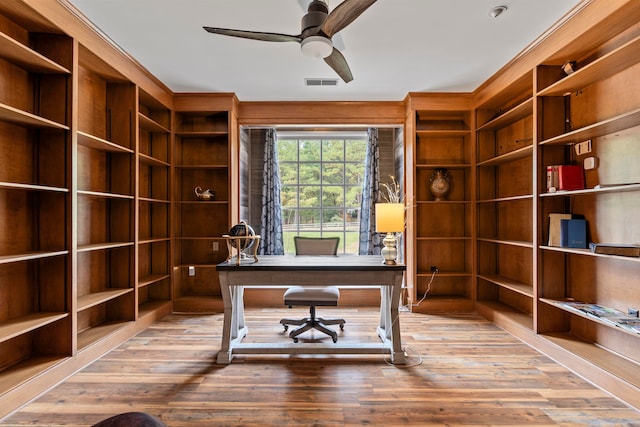 unfurnished office featuring ceiling fan and hardwood / wood-style floors