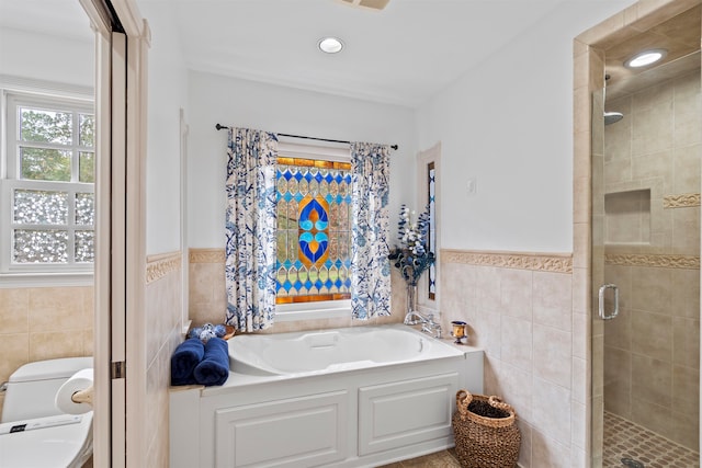 bathroom featuring tile walls and plus walk in shower