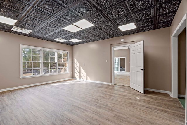 unfurnished room with light wood-type flooring