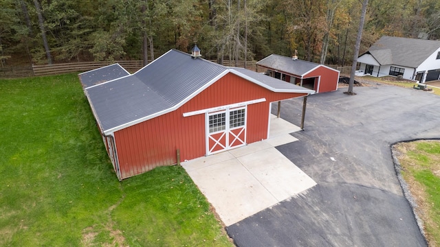 view of outbuilding featuring a yard