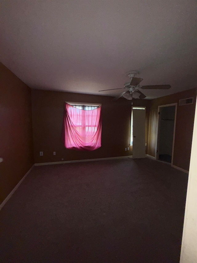 carpeted empty room featuring ceiling fan