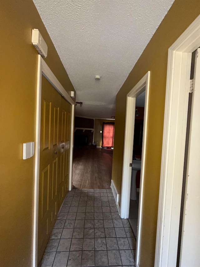 hall featuring a textured ceiling and hardwood / wood-style flooring