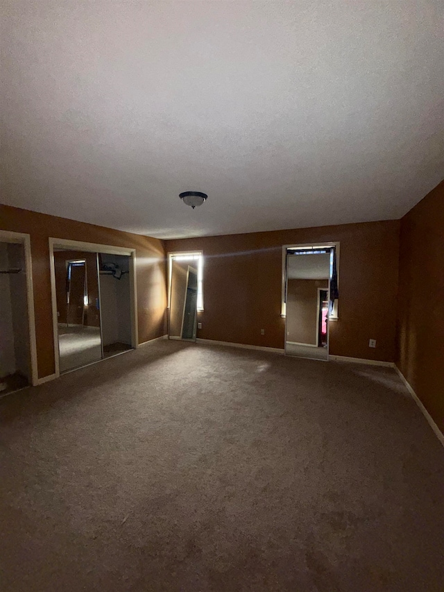 carpeted spare room featuring a textured ceiling