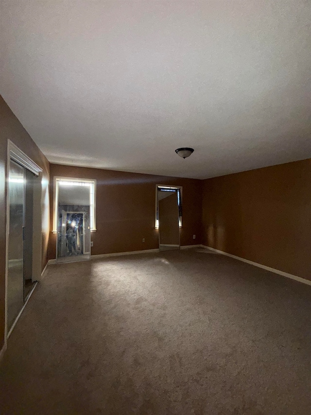 carpeted spare room featuring a textured ceiling