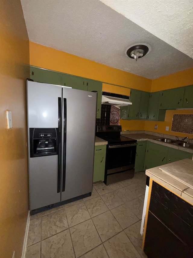 kitchen featuring black electric range oven, a textured ceiling, sink, stainless steel refrigerator with ice dispenser, and green cabinetry