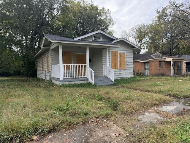 bungalow-style house with a porch and a front lawn