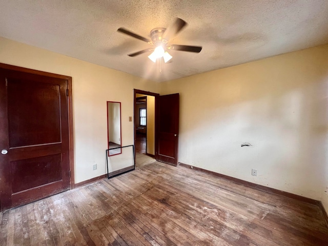 unfurnished bedroom with a textured ceiling, hardwood / wood-style flooring, and ceiling fan