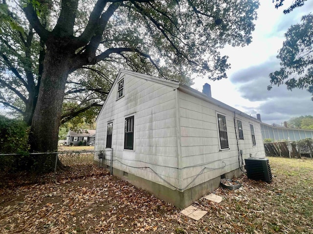 view of side of property with cooling unit