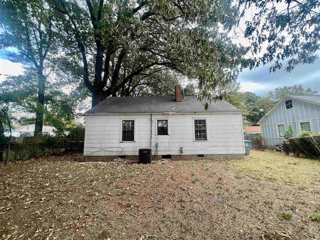 rear view of property with cooling unit