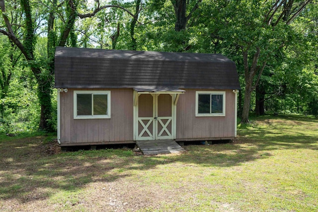 view of outbuilding with a lawn