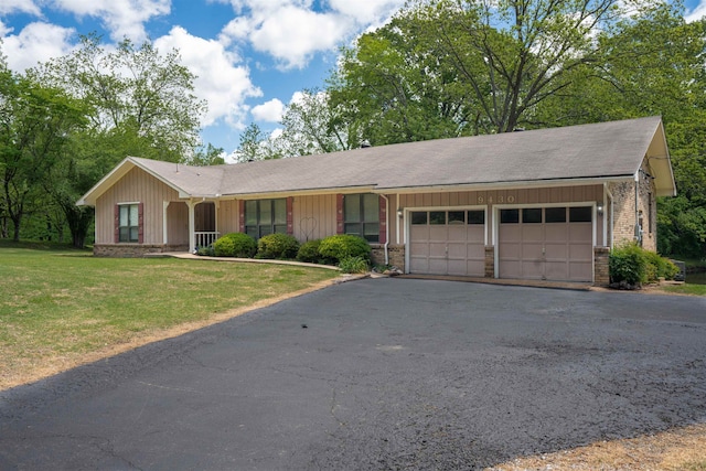 ranch-style home with a front yard and a garage