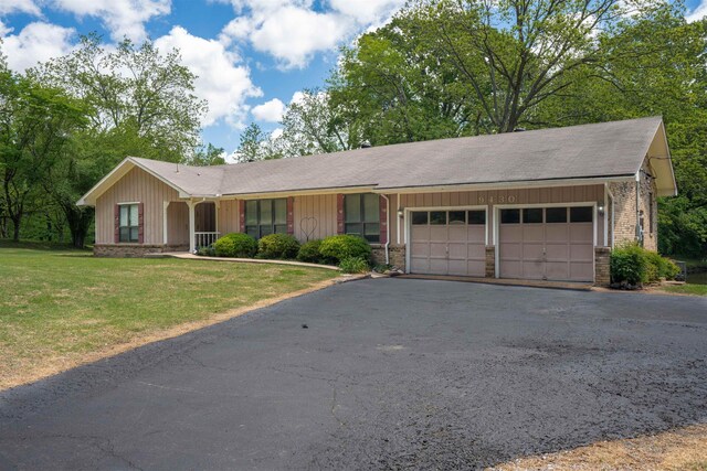 9430 Monasco Rd, Millington, TN 38053 - single story home featuring an attached garage, asphalt driveway, a front yard, and a shingled roof