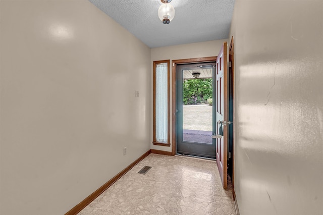 9430 Monasco Rd, Millington, TN 38053 - doorway to outside with baseboards and a textured ceiling