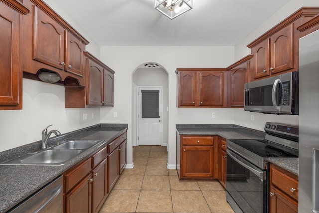 kitchen featuring sink, light tile patterned floors, and appliances with stainless steel finishes